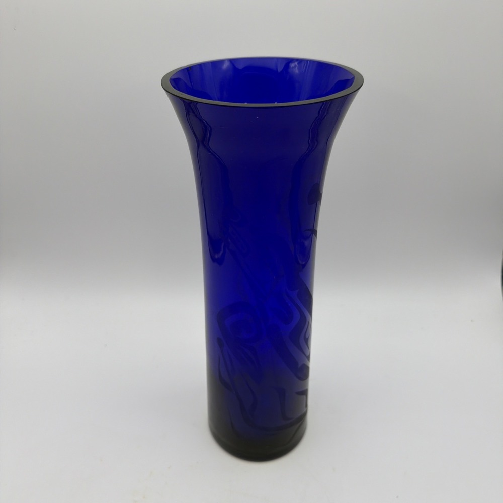 tall cobalt blue glass vase with a flared rim and an etched Design